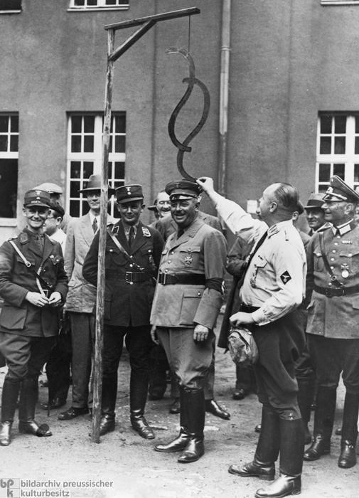 The End of the Constitutional State: Prussian Minister of Justice Hanns Kerrl Watches as the § Symbol (Traditionally Used to Denote German Legal Articles) is Hung from the Gallows (1934)